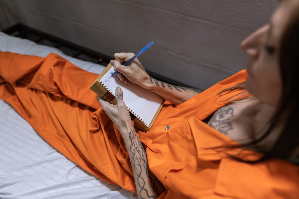 Image of someone who is writing a letter to help a loved one in prison.